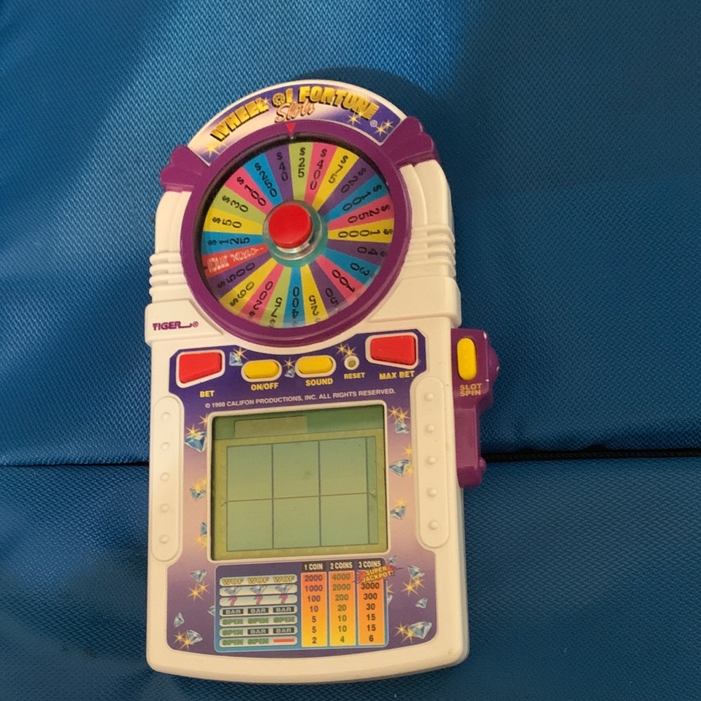 Tiger Electronics Wheel of Fortune Handheld Game - Purple and White